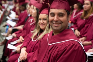 Full Tuition Awards Students in graduation gowns looking at the camera