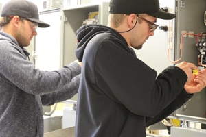 Two trades students working on electrical wiring