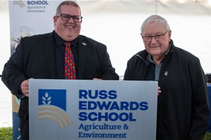 Russ Edwards School investment ACC President Mark Frison and Russ Edwards holding a Russ Edwards School sign