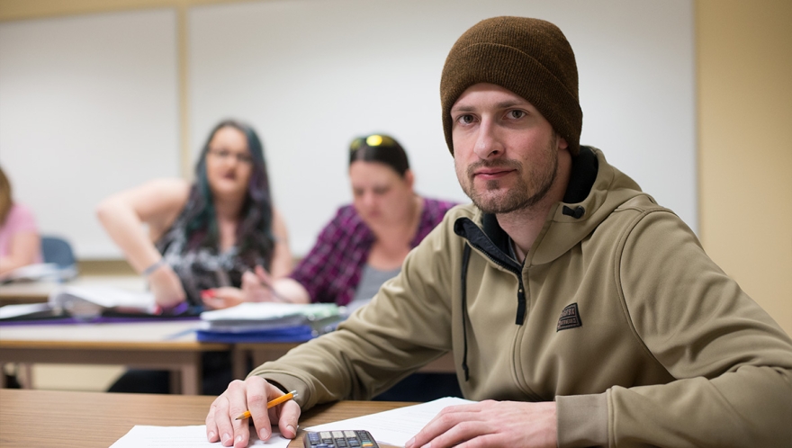 A student sitting in a classroom.